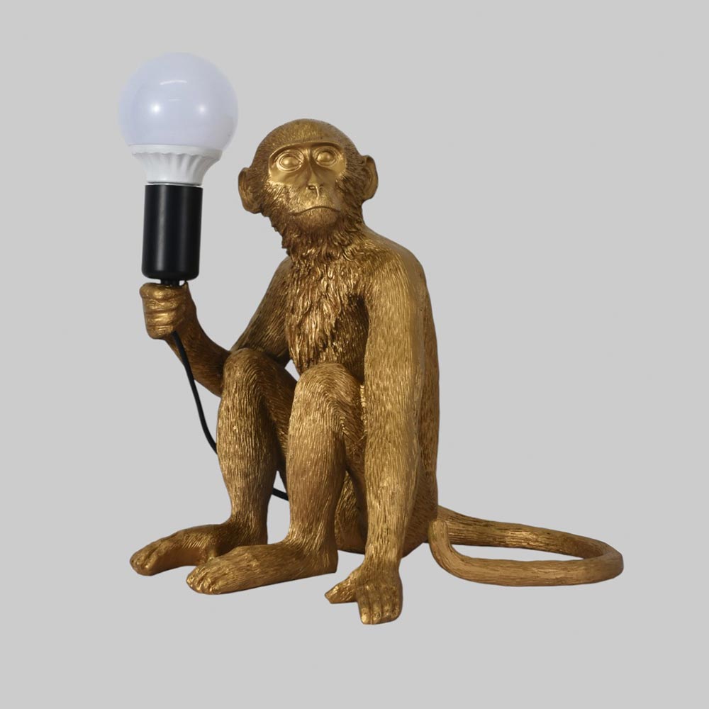 Lámpara de mesa E27 Mono sentado dorado